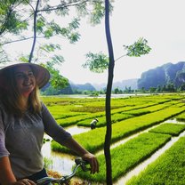 Girl on bicycle in Rice Field