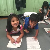 Two children coloring at Sangolqui Market