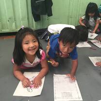 Two children coloring at Sangolqui Market