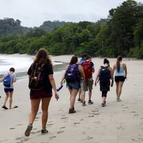 A group of USAC students walking along the beach in the Manuel Antonio National Park.