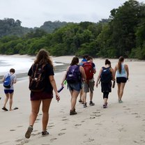 A group of USAC students walking along the beach in the Manuel Antonio National Park.