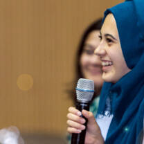 international students speaking in microphone at Qatar university 