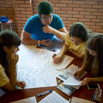 man teaching kids