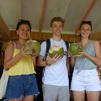 CET high school student smiling with fresh coconuts while studying in Havana, Cuba