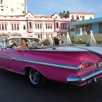 Havana, Cuba street with old, pink car.