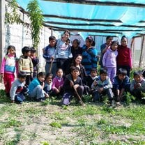Planting organic veggies with local elementary school Photo of local elementary school kids and intern just after planting some organic veggies at the school garden.