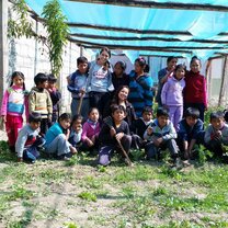 Photo of local elementary school kids and intern just after planting some organic veggies at the school garden. 