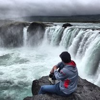 Sitting at the Edge of One of the Largest Waterfalls in Europe