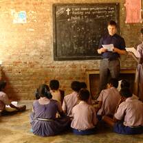 A student sharing with a group of children in India.