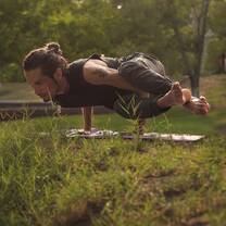 man doing yoga on the grass in cancun