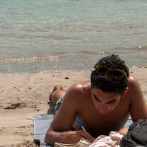 student studying on the beach