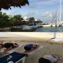 students doing yoga by the harbour