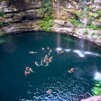 students swimming in a cenote - optional excursion
