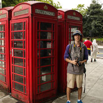 student with an old red London phone booth