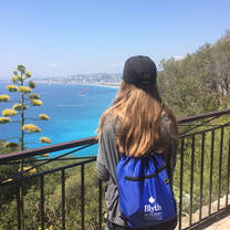 student wearing Blyth Academy bag overlooking the ocean