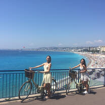 students riding bikes near beach in Nice
