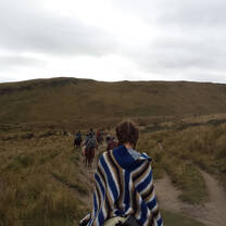 student riding horseback through Puembo countryside