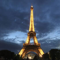 Eiffel Tower lit up at dusk