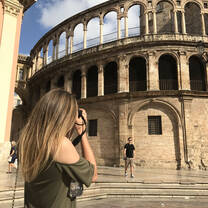 student taking picture of old building in Valencia