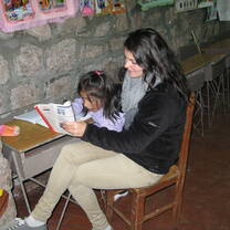 woman with child on her lap reading