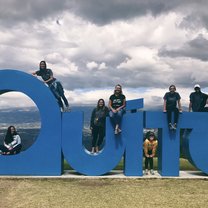 Students sit on giant Quito sign located in Parque Metropolitano.