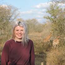Volunteer with giraffe