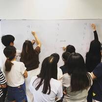 students writing on whiteboard
