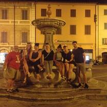 Students around fountain at night in italy
