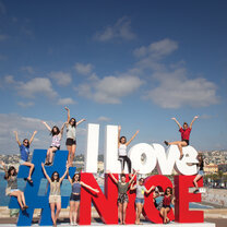 High School Semester Abroad! people standing on sign in Nice