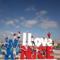 people standing on sign in Nice