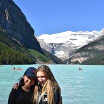 girls smiling outside in canada next to ocean and mountains