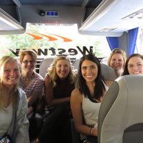 Brittney and classmates smiling big while taking a coach tour of London