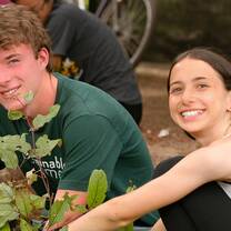 Male and female students plant trees in India