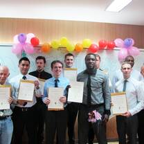 students holding certificates in classroom