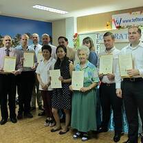 students holding certificates in classroom