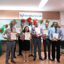 students holding certificates in classroom