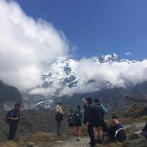 The group hiking the Hooker Valley Track, looking up at Mount Cook