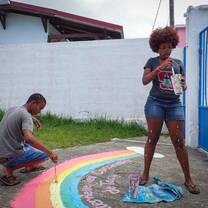 VISIONS participants painting a mural at one of the service sites