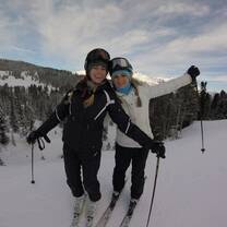 two girls skiing atop the Swiss alp mountains