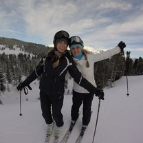 two girls skiing atop the Swiss alp mountains