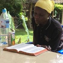 On our last session for the year, Anna sat outside and read her bible 