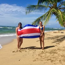 Two girls holding the Costa Rican flag in Punta Uva.