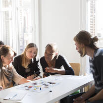 A new teacher working with a group of students