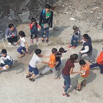 Volunteer and children playing in the street