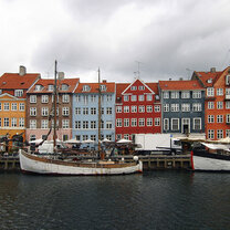 A photo of Danish architecture and boats in a port.