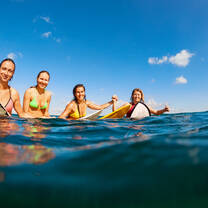 4 people on surfboards in the ocean