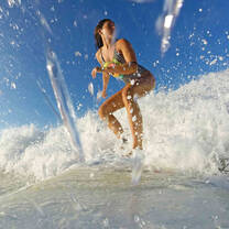 woman on surf board riding a wave