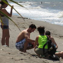Student playing with locals at the beach