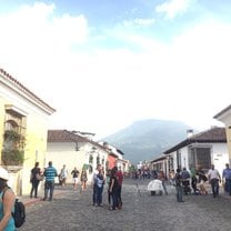 A picture of showing the volcanoes surrounding the historical city of Antigua, Guatemala.