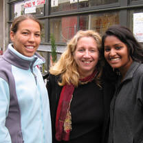 Three women smiling for a photo. 